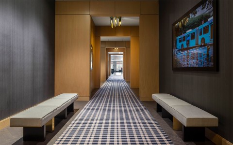 a long hallway with artwork on the walls