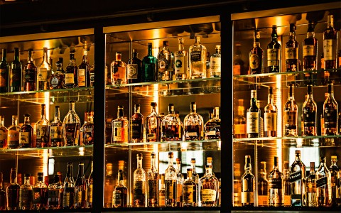 a wall of liquor with soft lighting