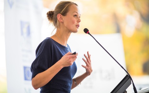 a woman talking at a podium