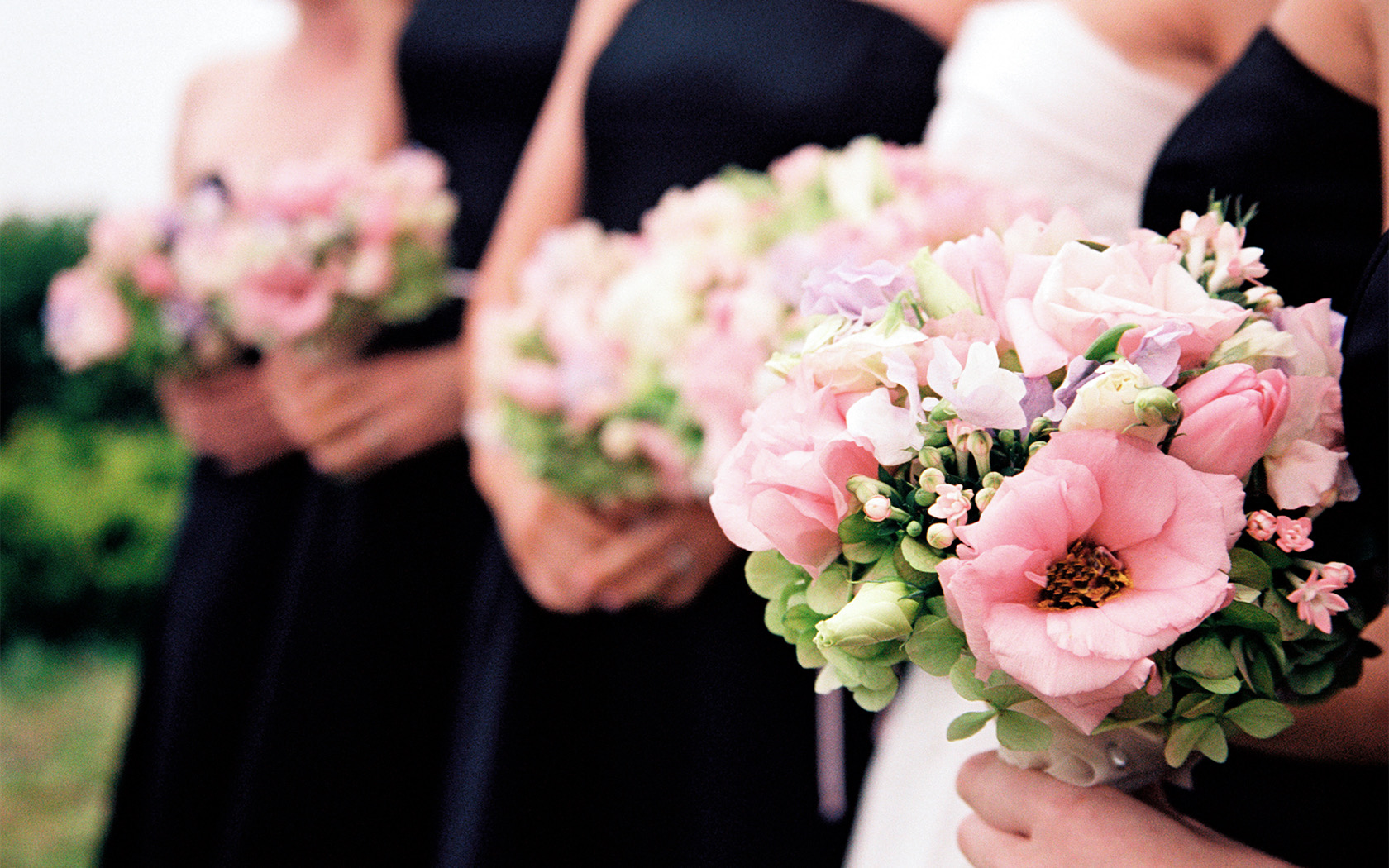 gallery close up of girls holding pink bouquets at a wedding
