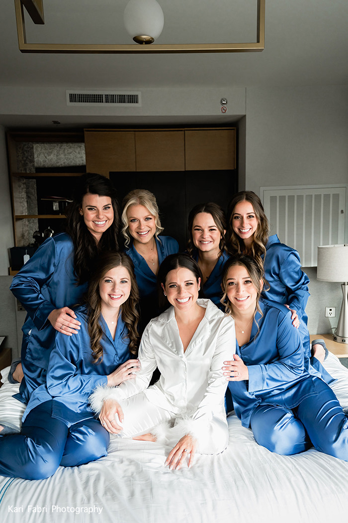 gallery group of women wearing robes and sitting on a bed together 