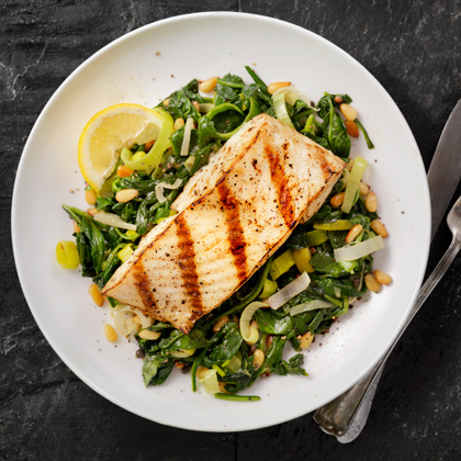 grilled fish served over sauteed greens 