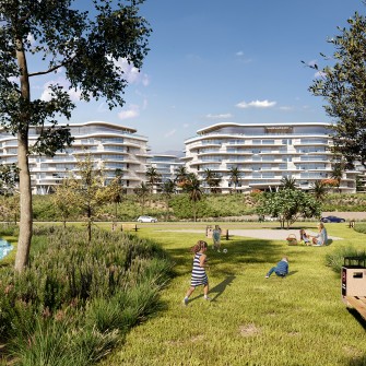 kids playing on the grass with large buildings in the background