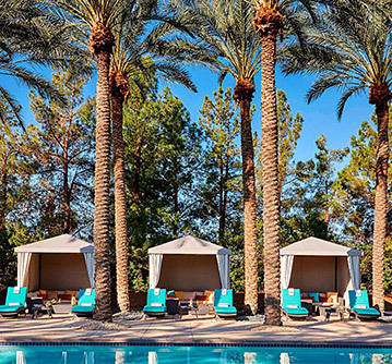 3 cabanas with teal chairs outside