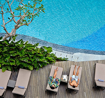 couple on a private area of the pool suntanning