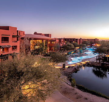 sun setting on red hotel buildings