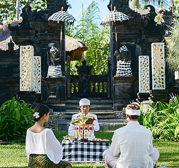 3 people performing a traditional ceremony outside