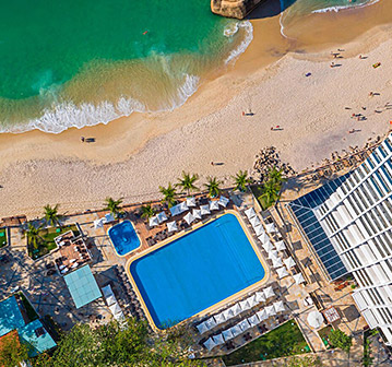 arial view of blue pool next to the beach