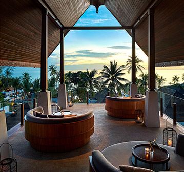 beautiful lounge chairs looking at a tropical sunset