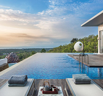 view of infinity pool on sunset